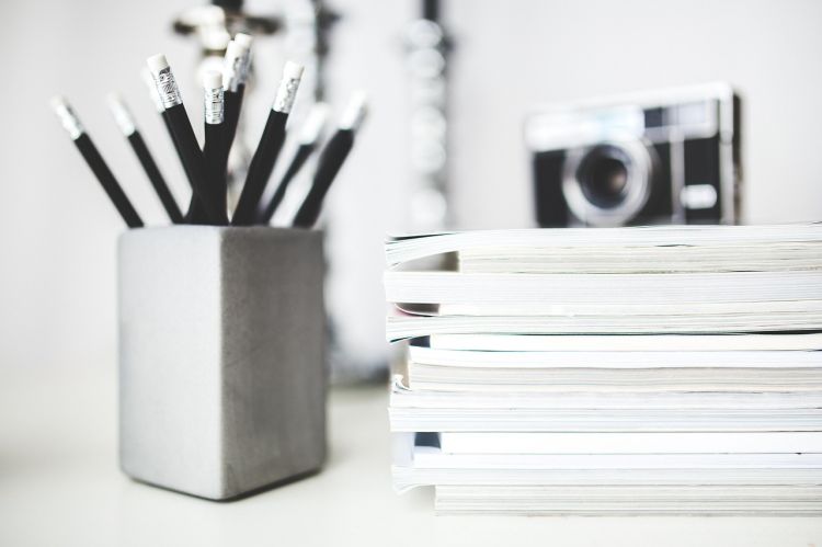 Image by Karolina Grabowska from Pixabay A bunch of pencil next to a stack of paper tablets