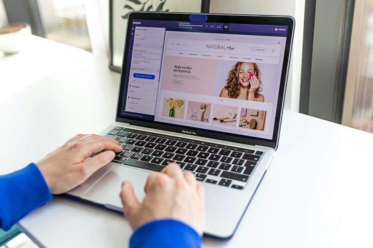 a person using a MacBook Pro to shop on an e-commerce website
