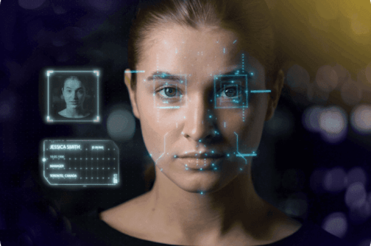 Woman looking at you and a computer screen